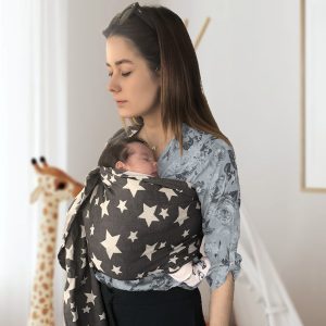 Mom with a newborn baby sleeping peacefully in a ring sling