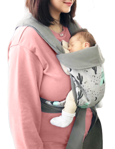 Tiny newborn just a few days old, calm in a babywearing mei tai with mom