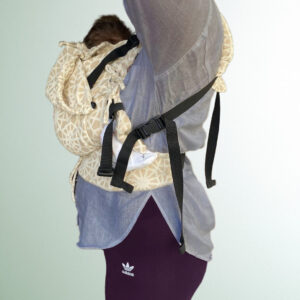 Newborn baby in a Luna Dream carrier, high above the incision area